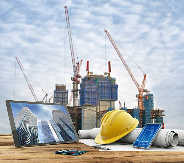 blueprints and safety helmet over a table in construction site